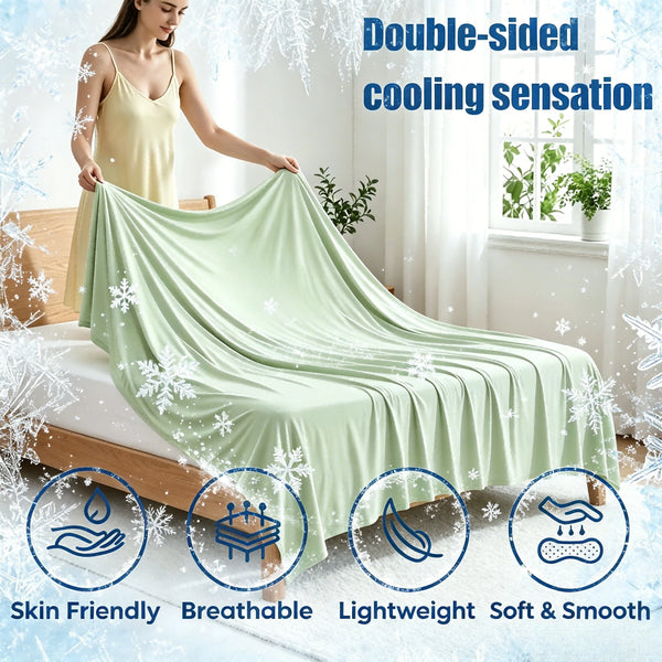 A woman is draped in a light green double-sided cooling silk blanket, highlighting its skin-friendly and breathable features.