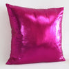 A square pillow cover in metallic magenta or pink with a shiny finish.