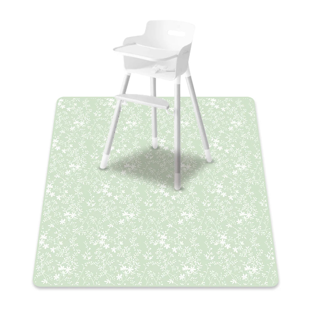 A white baby play mat with an anti-slip backing is shown on a light green surface.