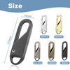 A set of metal zipper sliders in silver, gold, gun color, copper, and black finishes shown next to a large black zipper pull.