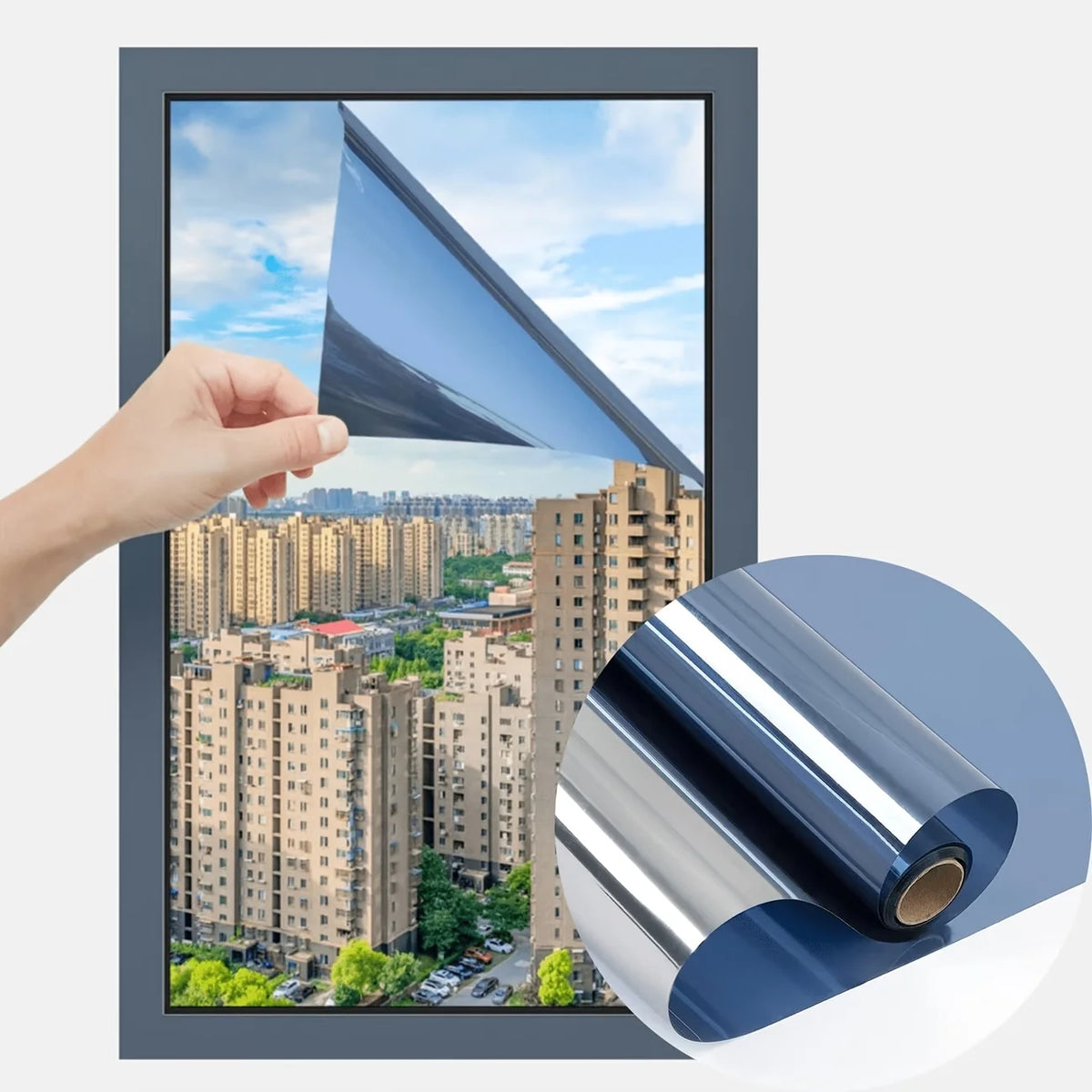 Hand holding a sheet of reflective mirror window film being applied to a window frame.