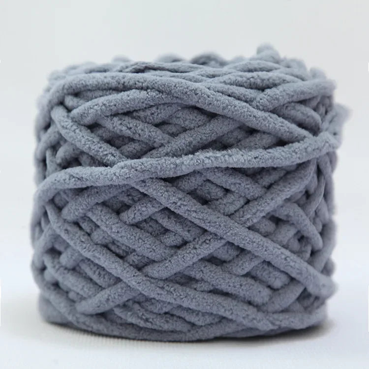 A ball of soft gray chenille knitting yarn for hand crafting