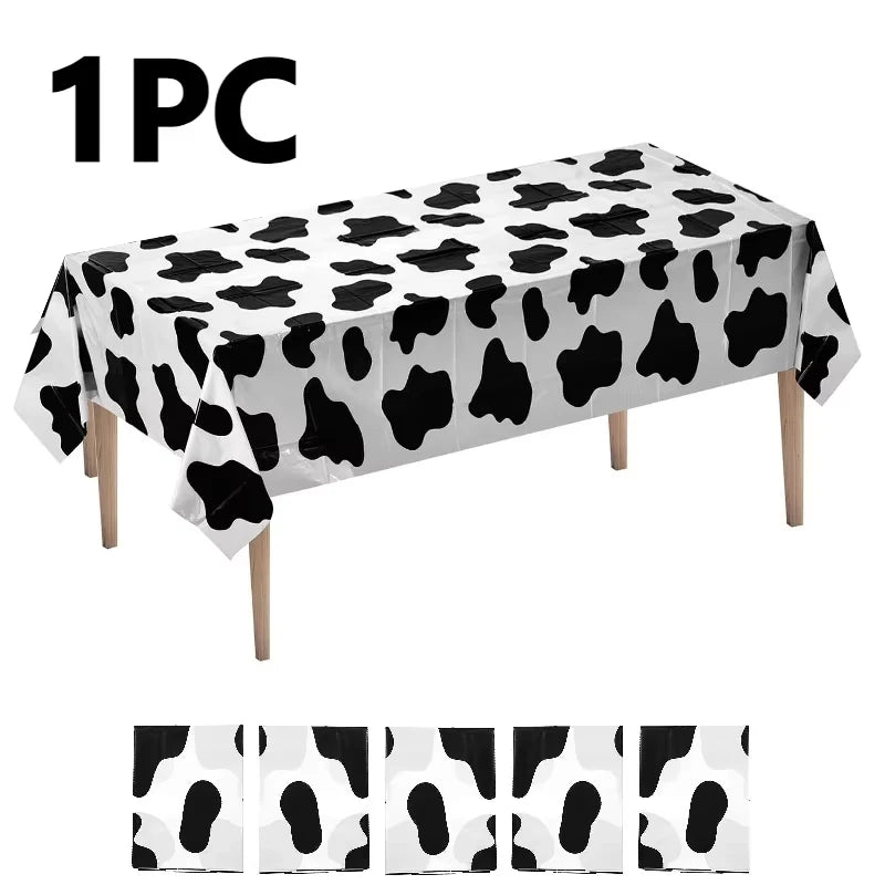 One piece of cow print disposable plastic tablecloth displayed on a surface.