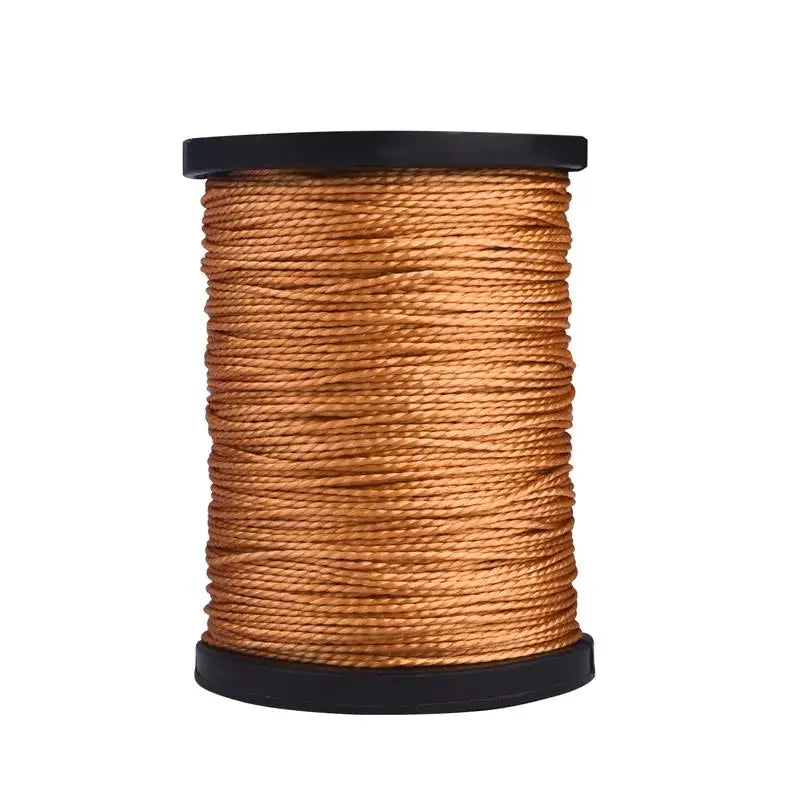 A spool of brown leather sewing awl and stitching kit thread on a black core.