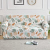 A floral print elastic sofa cover protector featuring green and terracotta leaves on a light background.