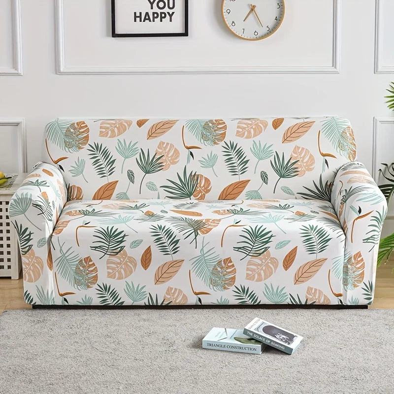 A floral print elastic sofa cover protector featuring green and terracotta leaves on a light background.