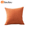 A square, textured orange linen cushion cover with a button closure.