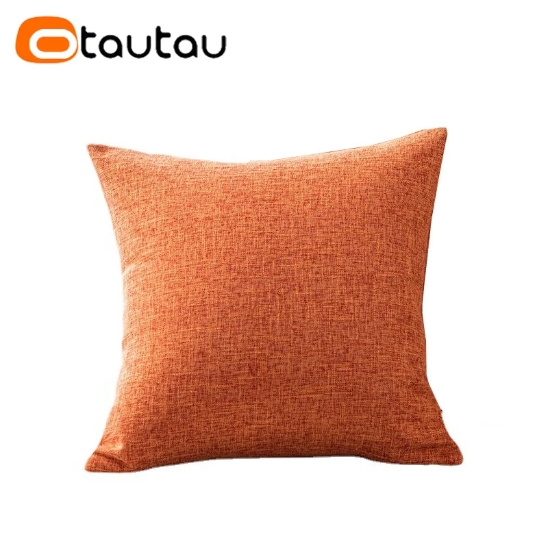 A square, textured orange linen cushion cover with a button closure.