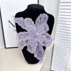 Purple floral sequin lace applique fabric patches displayed on a black mannequin.