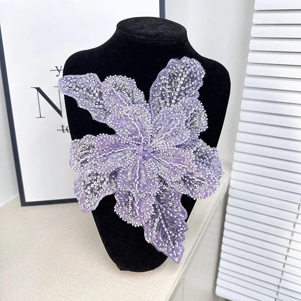 Purple floral sequin lace applique fabric patches displayed on a black mannequin.