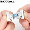 A hand is demonstrating a seamless magnetic button clasp, showing the mechanism used for bags and clothing.