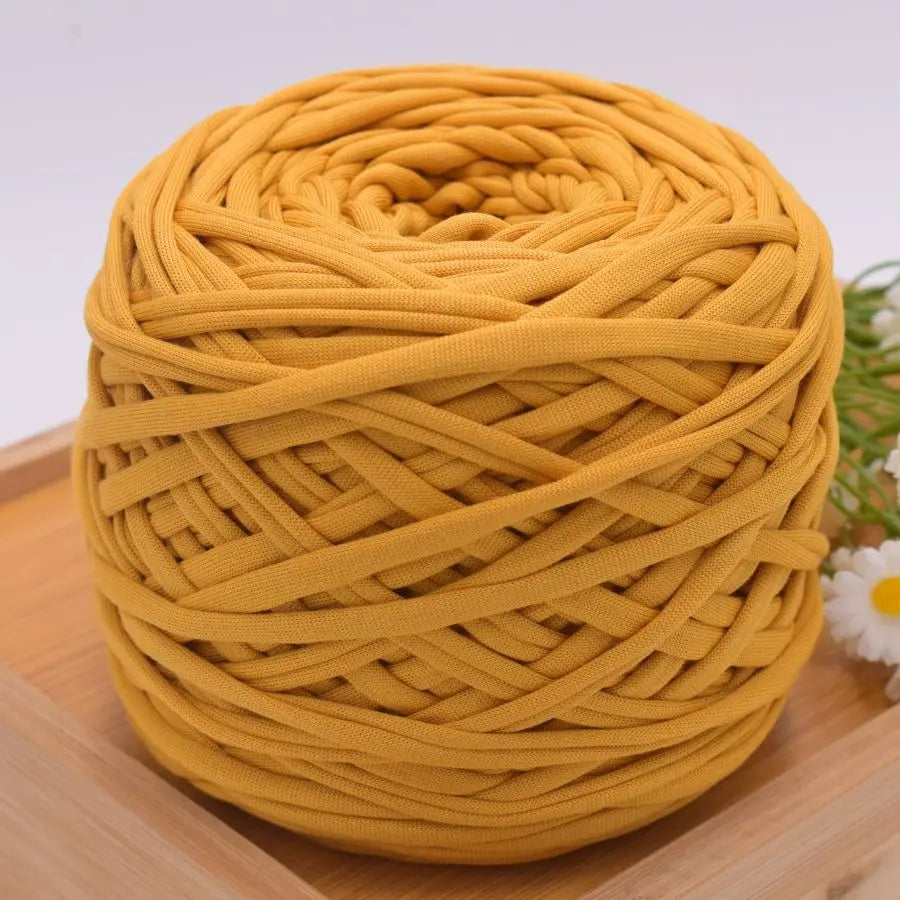 A ball of golden yellow craft yarn made of 100% polyester for knitting and DIY projects.