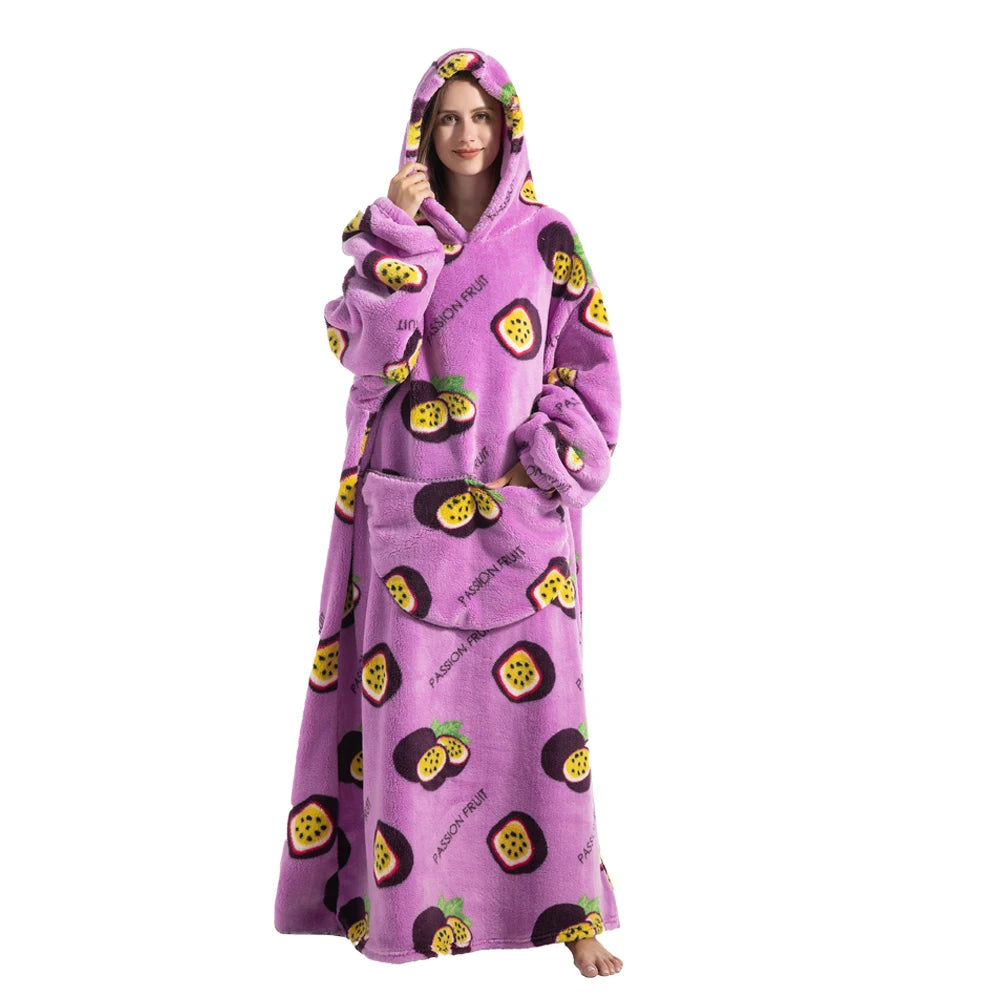A woman wearing a purple sherpa fleece oversized blanket hoodie with a fruit print on a white background.