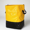 A heavy duty waterproof storage bag in bright yellow and black.