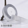 Roll of silver glitter organza ribbon for gift wrapping and DIY crafts