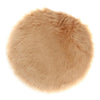 Round tan faux fur sheepskin area rug with a fluffy texture.