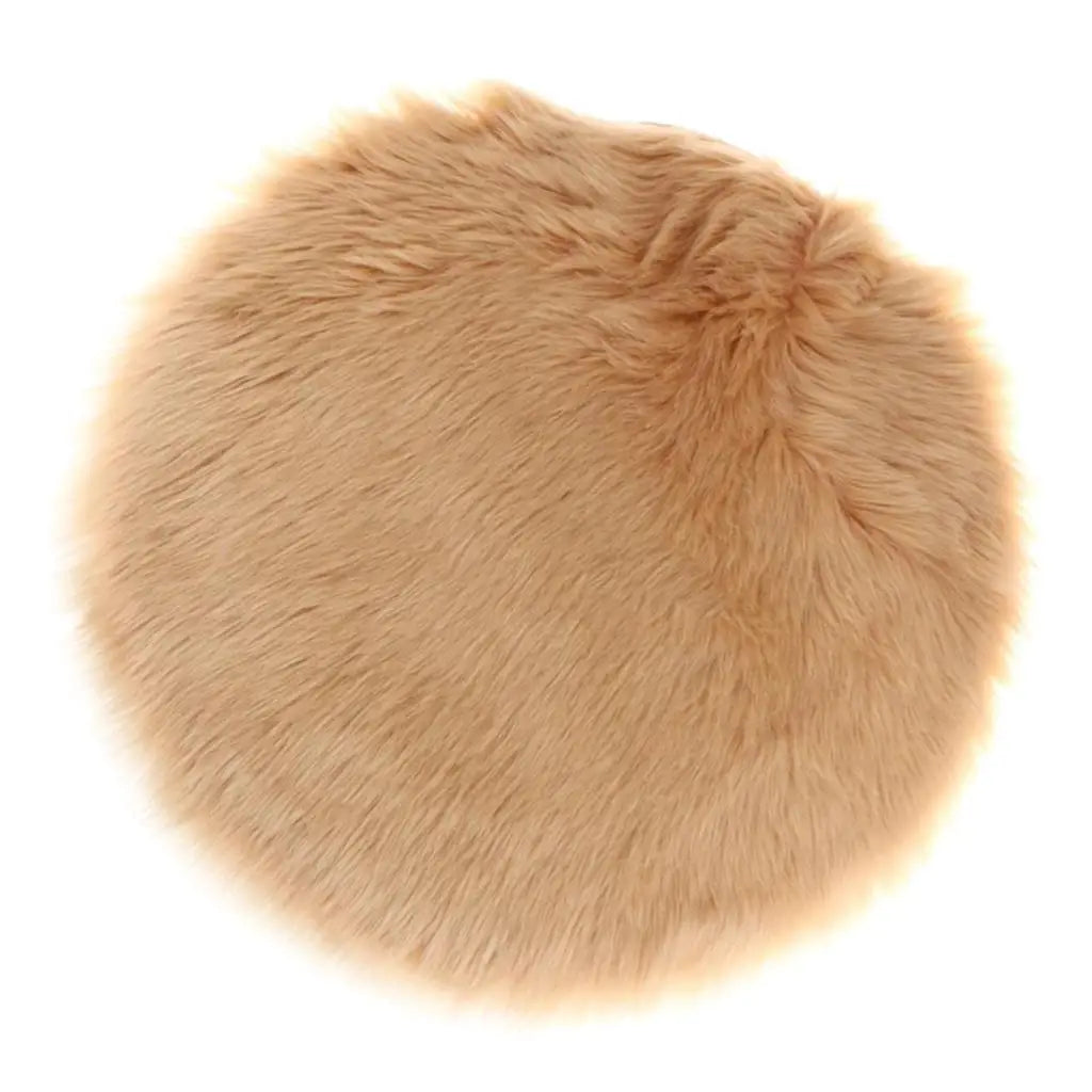 Round tan faux fur sheepskin area rug with a fluffy texture.