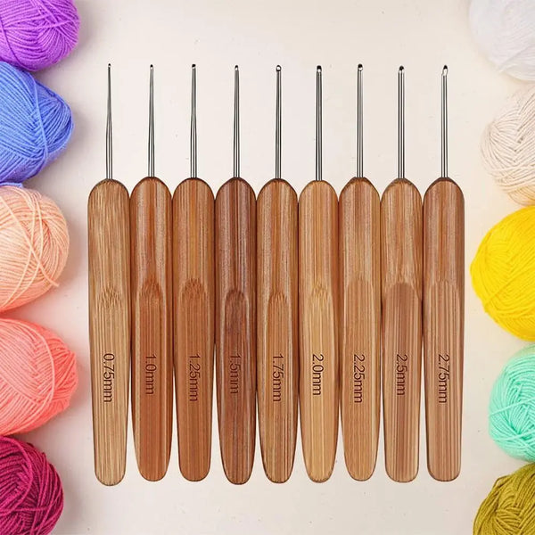 A set of wooden bamboo crochet and knitting needles in various sizes arranged horizontally.