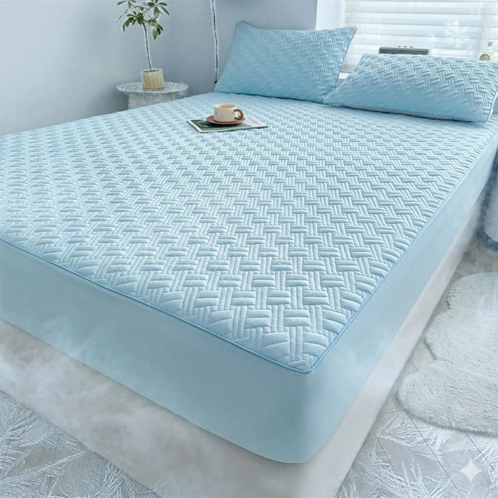 Light blue cooling spandex fitted sheet mattress protector on a bed with pillows and a cup.
