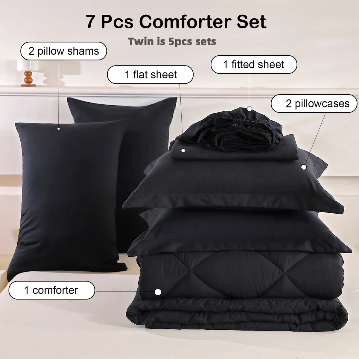 A set of 7 pieces including a comforter, sheets, pillow shams, and pillowcases in black for a twin bed.