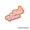 Orange and white embroidered patch with the text Fall Vibes