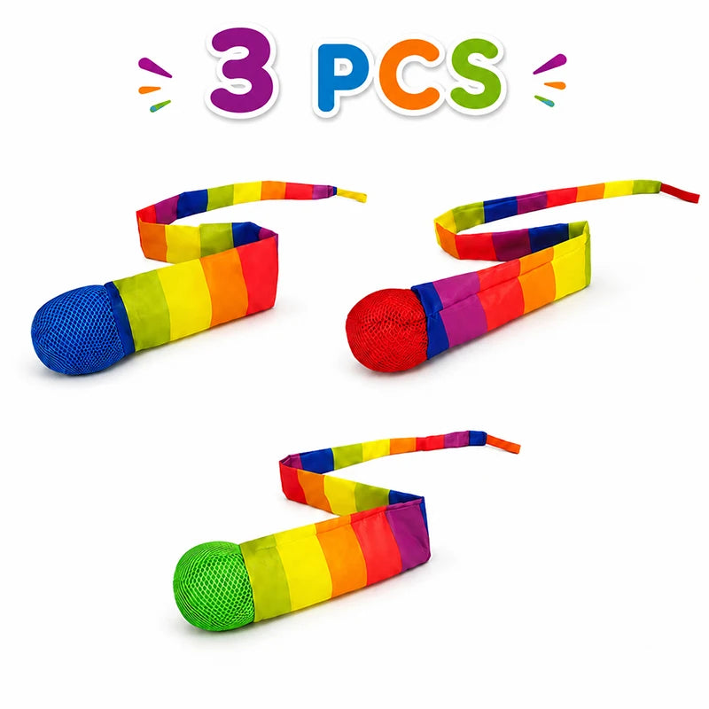 Three rainbow colored comet balls with soft tails shown against a white background.