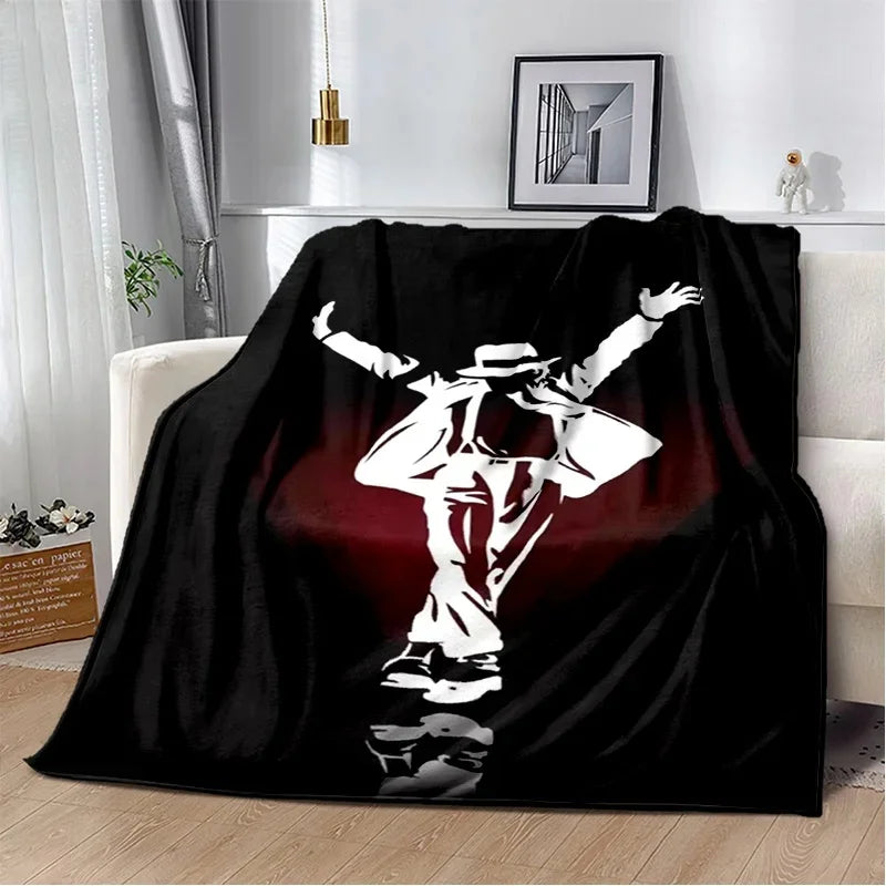 A black flannel throw blanket featuring a white retro printed design of a person in a wide stance.