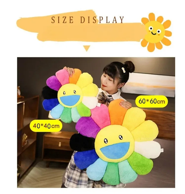 A plush sunflower cushion with a smiling face is displayed against a dark background.