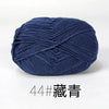 A ball of dark blue organic cotton 4ply knitting yarn for crafts.