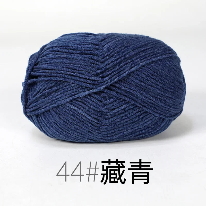 A ball of dark blue organic cotton 4ply knitting yarn for crafts.