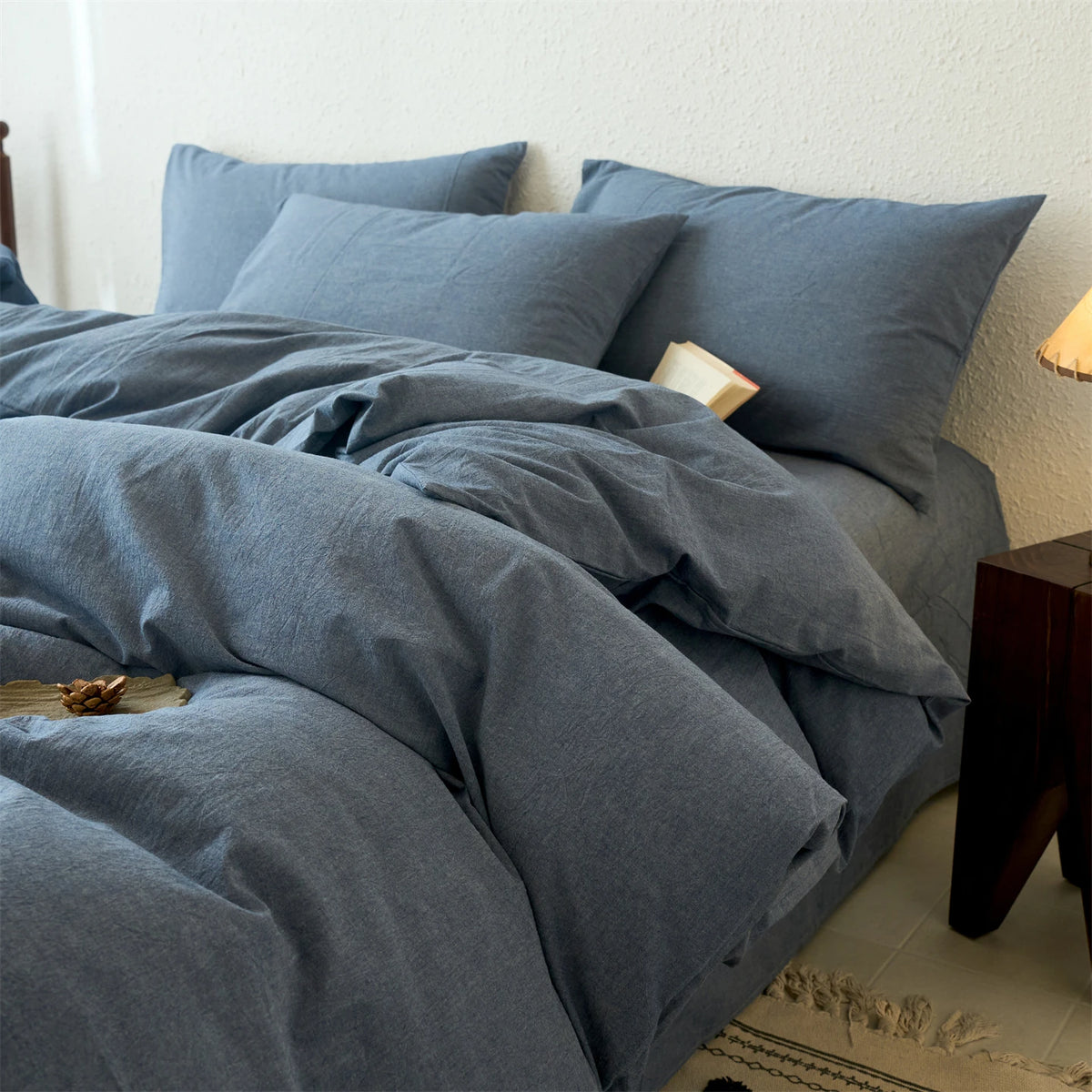A light blue cotton yarn-dyed duvet cover with matching pillows and bedding on a bed.