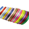 A variety of gold-edged satin ribbons in multiple colors are displayed in a row.