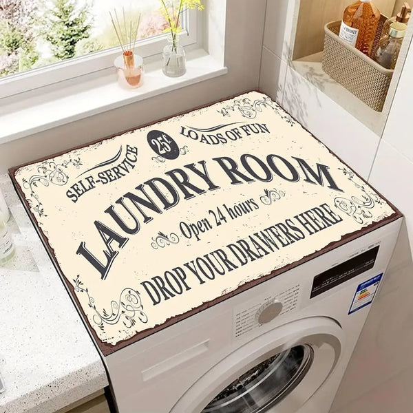 A laundry room featuring a white washing machine with a decorative label on the door and a window view.