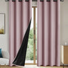 Pair of floor-length mauve curtains with black panels and grommets hanging in a light-filled room.