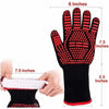 A black heat resistant BBQ glove with red accents and silicone grip shown next to a hand.
