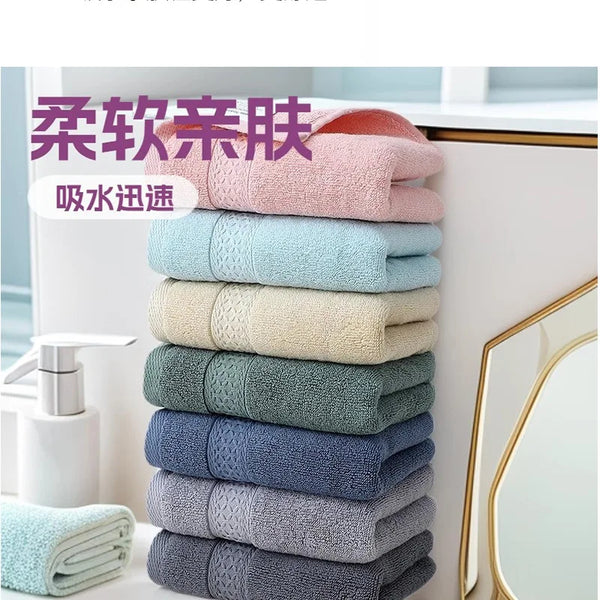 A stack of six pink, blue, and gray pure cotton face towels displayed next to a mirror.
