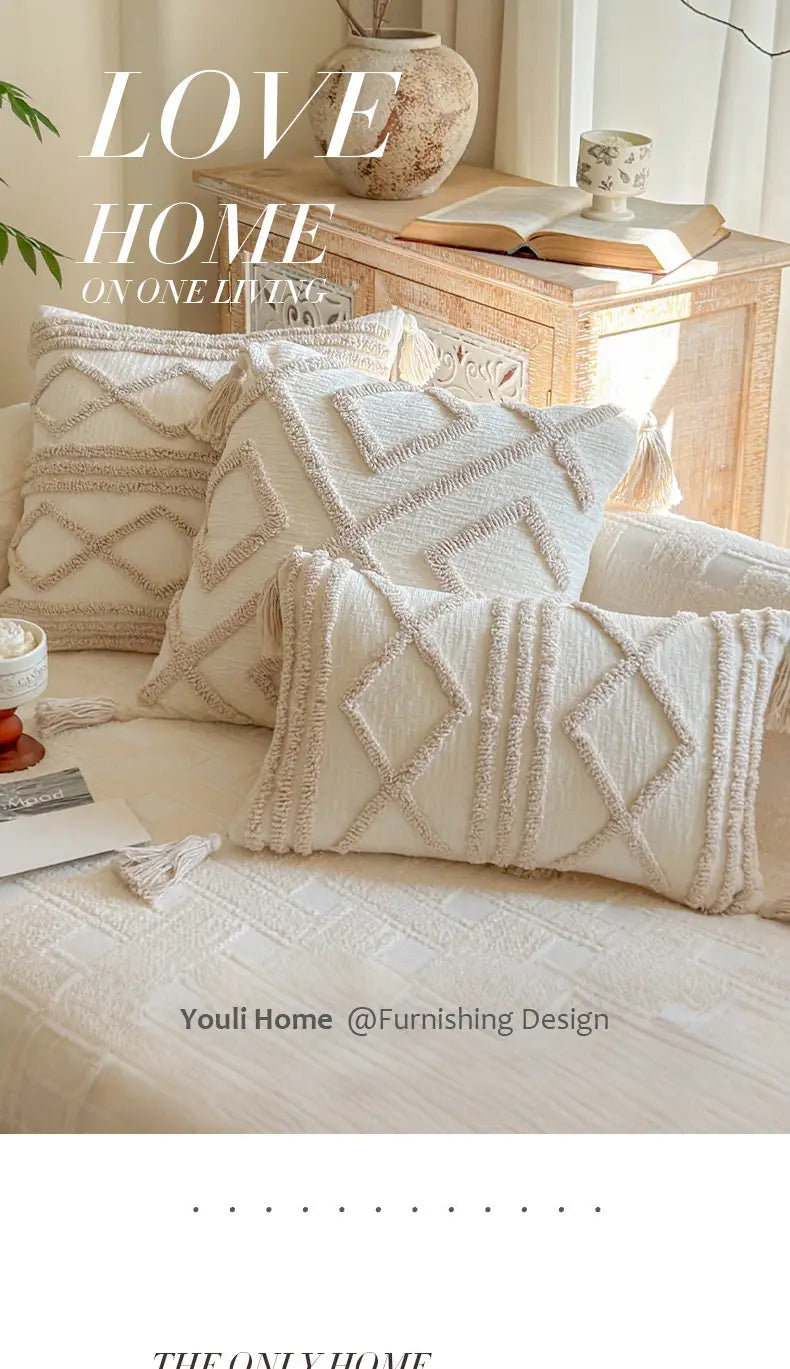 A close-up of cream knit pillow covers on a sofa and bed, styled with natural wood and pottery.