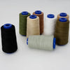 A collection of spools of heavy-duty waterproof sewing thread in various colors including green, beige, white, and brown.