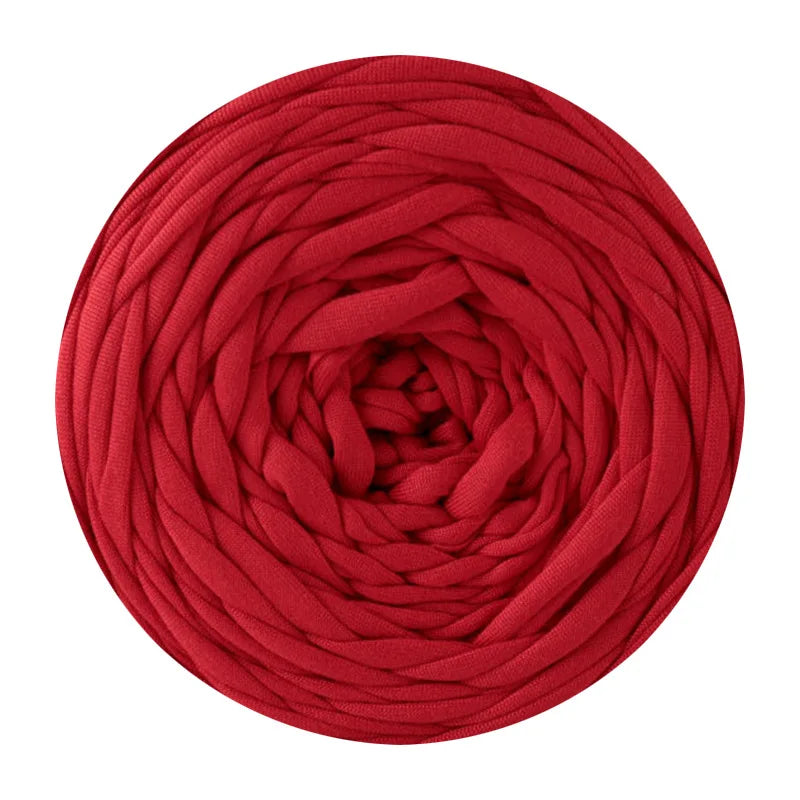 A ball of deep red soft T-shirt yarn used for crochet