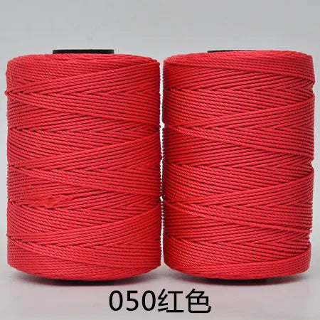 Two spools of red hand knitting and crochet cord for crafting