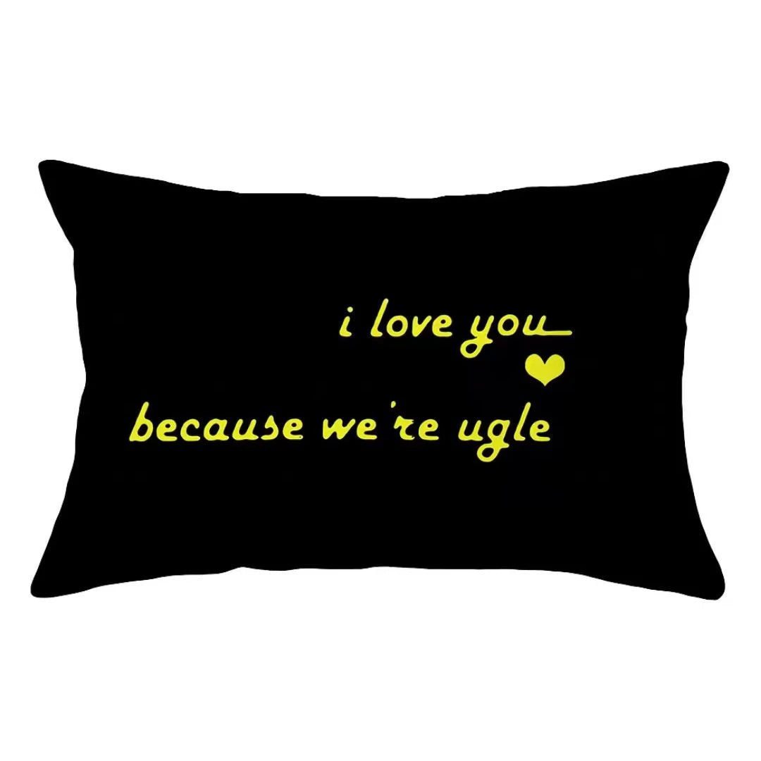 Black decorative pillow cover with yellow text that reads I love you because we're ugly
