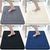 Four variations of ultra soft memory foam bathroom mats in gray, beige, black, and blue shown being used by feet.