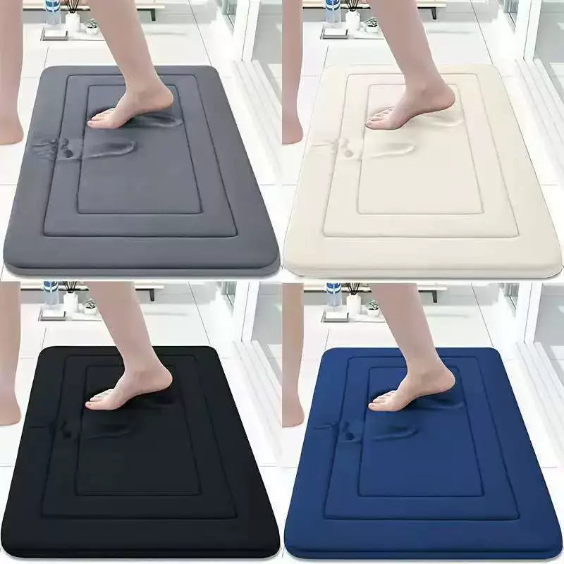 Four variations of ultra soft memory foam bathroom mats in gray, beige, black, and blue shown being used by feet.