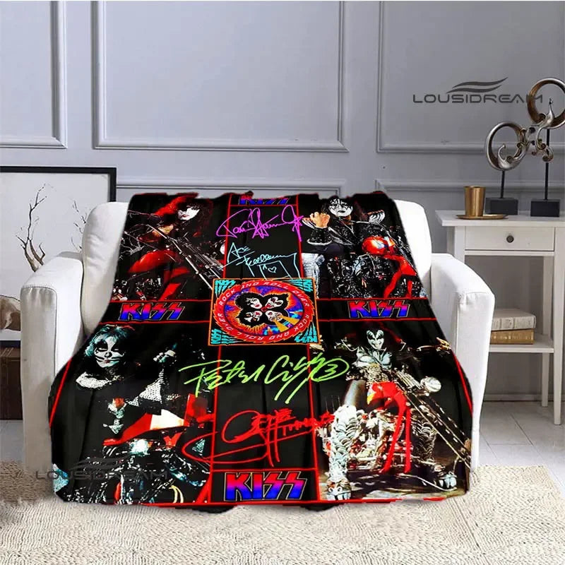 A black and red printed flannel travel blanket draped over a white sofa.
