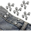 Adjustable button pins for jeans showing various silver and gold-toned pins on denim fabric