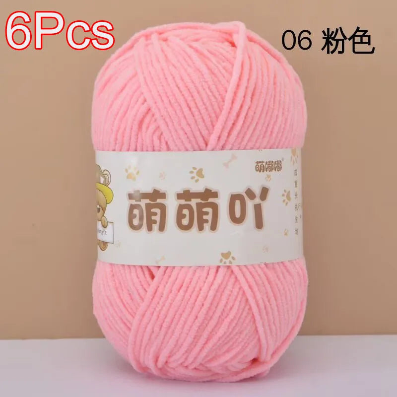 A skein of pink chenille yarn is shown against a neutral background.