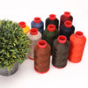 A collection of heavy duty nylon sewing thread spools in various colors including red, orange, green, blue, and black.