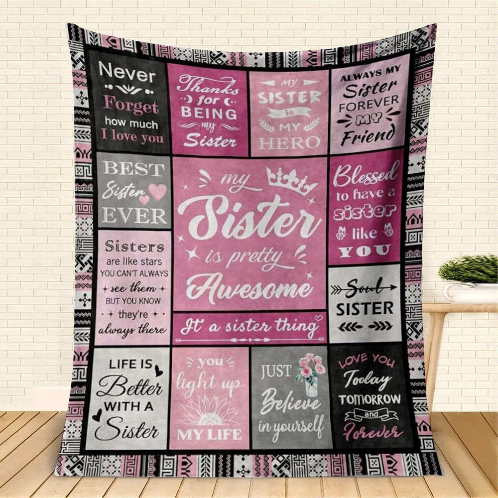 A pink and black patterned throw blanket featuring text like Never Forget and My Sister is pretty Awesome