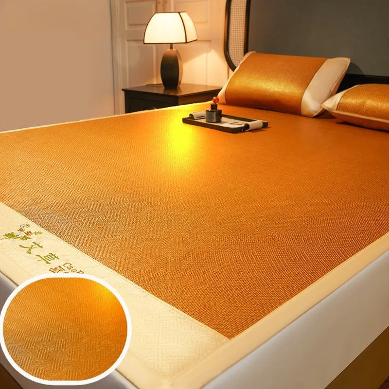 A close-up view of a golden orange natural bamboo cooling mat placed on a bed, with a lamp and decorative pillows nearby.