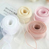 Rolls of wavy edge organza ribbon in white and pink shades for crafting